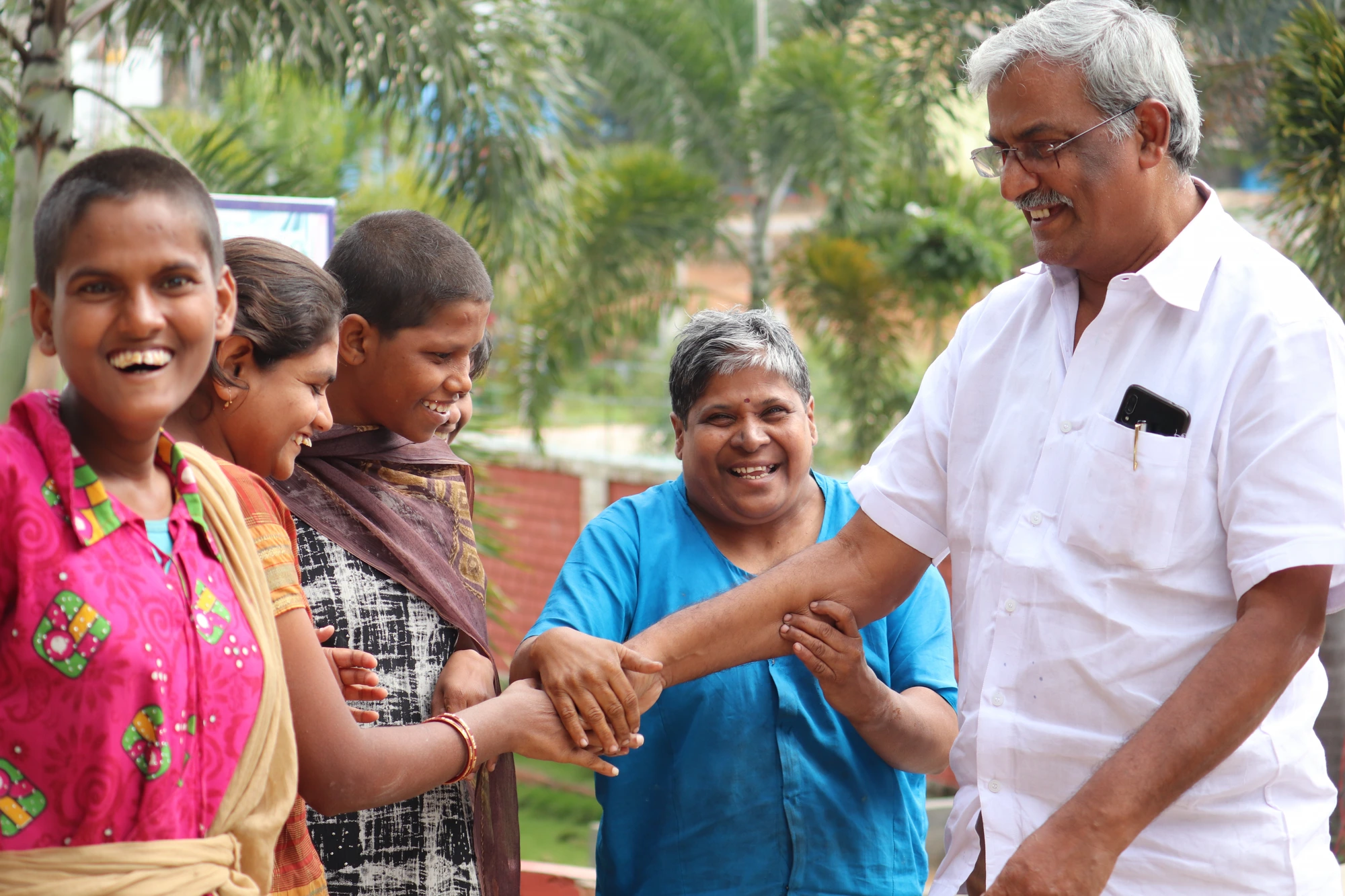 Children laughing with our Secretary on campus